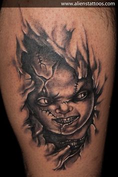 a black and white tattoo with a creepy face