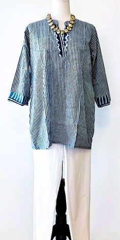 People love these kurta tops for their simple, yet ultra-flattering shape. This tunic is soft to touch, almost feels like silk, in a dramatic hand block print in a geometric pattern. Handmade cotton tunic accentuated with trimmings around the neck and sleeve with a pocket. This Kurta is made from the finest signature cotton. Featuring split round neckline with a contrasting front placket and cuffs. 3/4 sleeves, inset side pocket, and side vents. Classic, tailored and in fashion year round. This Cotton Tunic, Cotton Kurta, Hand Block Print, Womens Tunics, Jean Leggings, Side Pocket, Blue Stripes, Block Print, Round Neckline