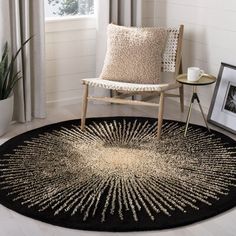 a living room area with a chair and rug on the floor in front of a window