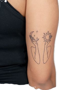 a woman's arm with a tattoo on it that has the sun and moon in her hands