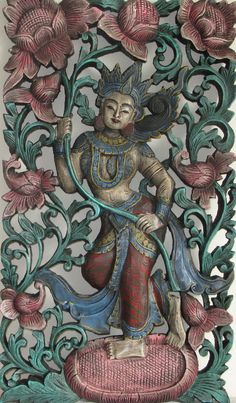 an intricately carved wall hanging depicting a person holding a staff and surrounded by flowers