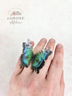 This butterfly ring who beautifully captures the magic of nature is an outfit changer and a real eye-catcher. Looks gorgeous with anything! Handcrafted from soft natural silk, this ring features a beautiful butterfly that will brighten up your look. The base of the ring is adjustable, so it will fit any finger size. Product specifications:     * handmade of silk;     * wingspan is about 5 cm     * adjustable size;     * the butterfly has three layers of silk;     * realistic look. Due to the pro Unique Handmade Butterfly Ring, Bohemian Butterfly Ring As A Gift, Bohemian Butterfly Ring As Gift, Bohemian Butterfly Ring For Gift, 3d Wings, Organza Butterfly, Peacock Butterfly, Gothic Gifts, Boho Style Jewelry