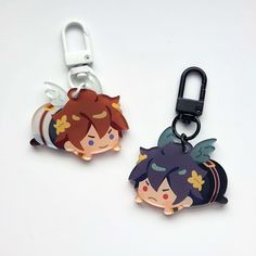 two key chains with cartoon characters on them