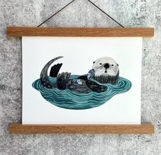 an animal is floating in the water on top of a wooden frame hanging from a wall