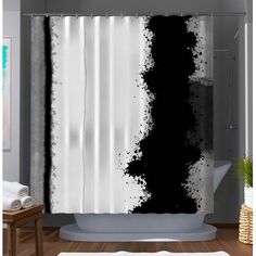 a shower curtain with black and white paint splattered on it in a bathroom