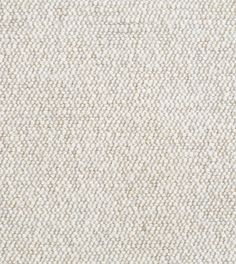 an upholstered white and beige fabric textured with small, wavy lines on the surface