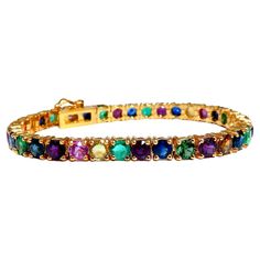 Gem Line. 17.20ct. Natural Blue/Yellow / Pink Sapphires, Green Garnet, Emerald, Ruby & Diamonds bracelet. Full round cuts, great sparkles. Clean Clarity & Transparent. (1) .35ct Natural Round Brilliant Diamond. H-color Vs-2 clarity Secure pressure clasp and safety catch. 18.4 grams. 14kt. yellow gold. Measures 7 inches (wearable length) 5.2mm wide. 37 stones $15,000 Appraisal Certificate to accompany Diamonds Bracelet, Gold Bracelet Set, Ruby Bracelet, Emerald Bracelet, Green Garnet, Tennis Bracelet Diamond, Ruby Diamond, Natural Sapphire, Sapphire Diamond