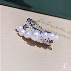 Highline: Famous Style Product Information OriginJapan MaterialAkoya Pearl, 18k White Gold, and Natural Diamonds DimensionsCustomize Pearl Shaped: Round Size: 6-6 mm Quality: AAA Nacre: Very Thick Color: White Luster: Aurora Accessories Metal: 4.4 g of 18k White Gold Other: 0.25 ct of SI Quality Natural Diamonds Aurora Accessories, Akoya Pearl Ring, Pearl Chandelier Earrings, Akoya Pearl Earrings, Golden South Sea Pearls, Metal Accessories, Bow Earrings, Pearl Types, Akoya Pearls