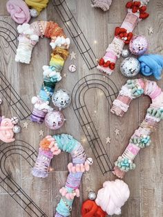 many different types of knitted toys on a wooden floor