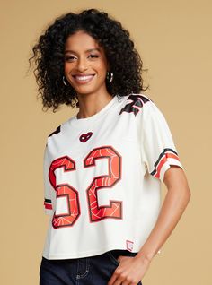 Show some love for your favorite Marvel redhead with this Spider-Man-inspired jersey! Featuring a printed design of "62" and an embroidered heart on the front  this jersey includes embroidered "Watson" lettering on the back. With "MJ" lettering on the shoulders and a cropped fit  this top is perfect for game days.A BoxLunch Exclusive!Recycled polyesterListed in women's sizes; unisex silhouetteWash cold with like colors; dry lowDo not iron over printImported Graphic Print Jersey For Fan Apparel, Graphic Print Jersey For Football Game Day, Short Sleeve Jersey With Graphic Print For Fans, Graphic Print Short Sleeve Jersey For Fan Gear, Varsity Jersey With Graphic Print For Fans, Sports Fan Cotton Crew Neck Jersey, Fan Gear Jersey With Graphic Print, Sports Fan Cotton Jersey With Crew Neck, Cotton Sports Fan Jersey With Crew Neck