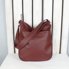 "If you value sophisticated accessories and you're looking for a multifunctional bag in gorgeous color, you are in a good place. This simple burgundy hobo purse looks great as shoulder or crossbody tote. Fits really well with any womens casual outfit. Made of high quality vegan leather. One of the bags perfect for everyday use - for work, shopping or little talks with your best friend. Easy to pack, large enough for all your items on the go. Cotton lining with three pockets, one of them fastened Leather Work Bag, Vegan Purses, Hobo Crossbody Bag, Hobo Purse, Large Shoulder Bags, Leather Work, Work Bag, Womens Casual, Crossbody Tote