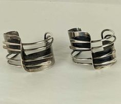 For Sale on 1stDibs - Pair of Iconic Art Smith 'Modernette' Cuffs from the 1940's in sterling silver. Pioneering jeweler Art Smith created some of the most iconic designs in Contemporary Metal Cuff Bracelet, Modernist Polished Cuff Bracelet, Vintage Polished Cuff Jewelry, Modernist Polished Cuff Bracelet For Formal Occasions, Modernist Cuff Bracelet With Polished Finish, Contemporary Silver Cuff Jewelry, Adjustable Modernist Cuff Bracelet For Formal Occasions, Modernist Polished Cuff Jewelry, Modernist Polished Silver Cuff Bracelet