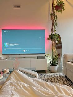 a flat screen tv sitting on top of a entertainment center