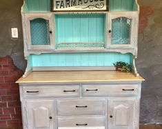 an old fashioned hutch is painted blue and white