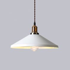 a white light hanging from a ceiling with a brown cord attached to the end of it