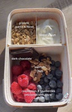 an open container filled with yogurt, granola and raspberries on top of each other