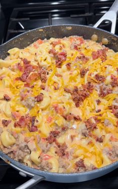 a pan filled with macaroni and cheese on top of a stove