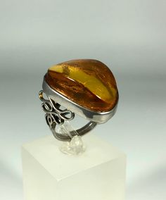 Discover the timeless elegance of our Spectacular Orange-Brown Amber Ring, expertly crafted for ladies in stunning 925 sterling silver. This exquisite piece features natural Baltic Sea amber, renowned for its unique beauty and healing properties. Perfect for any occasion, this amber ring will add a touch of sophistication to your jewelry collection. Product Details: Material: 925 Sterling Silver Stone: Natural Baltic Sea Amber Color: Spectacular Orange-Brown Design: Minimalist Style Ring Size: 8 Timeless Oval Rings With High Luster, Elegant White Gold Cabochon Rings, Elegant White Gold Rings With Cabochon, Fine Jewelry With Polished Edges For Formal Events, Fine Jewelry With Polished Edges For Formal Occasions, Sterling Silver Jewelry With Shiny Finish And Oval Shape, Oval Sterling Silver Jewelry With Shiny Finish, Timeless White Gold Cabochon Rings, White Gold Rings With Shiny Finish For Gift