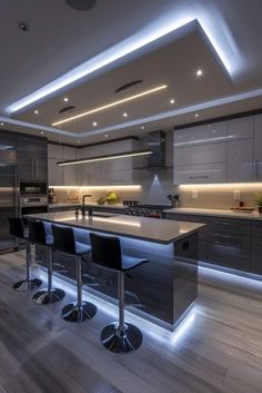 a modern kitchen with an island and bar stools