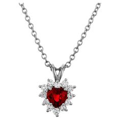 Ruby and diamond pendant necklace. This piece begins with a heart shaped ruby mounted in a platinum setting with a halo of 11 round brilliant cut diamonds. GIA has certified the ruby as simple heat with minor residue. An 18 inch platinum chain. 1 heart shaped vivid Pigeon blood red Ruby, approx. total weight .90cts, SI1, natural color simple heat and minor residue, GIA certificate #1152754325. 11 round brilliant cut diamonds, approx. total weight .33cts Top to bottom: 16mm or .63 inch Width: 10. Ruby Heart Pendant, Platinum Chain, Gia Certificate, Ruby Heart, Heart Shape Pendant, Diamond Pendant Necklace, Round Brilliant Cut Diamond, Brilliant Cut Diamond, Pigeon