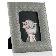 a photo frame with a woman's face in the middle and a hair comb on top