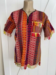 This pretty huipil top is from Guatemala. It is traditional weave fabric with a simple home made styling.  Please check measurements before purchasing - I believe this is a woman S/XS or a youth Large..   All measurements are laying flat: underarm to underarm/bust - 20.5", waist 19.5", hips - 2" and length from shoulder to hem is 26". FREE shipping in the USA.  This is for shipping with Delivery Confirmation.  ALL FUNDS MUST BE PAID IN US DOLLARS. Buyer to pay Weave Fabric, Simple Home, Us Dollars, Simple House, Home Made, Traditional Outfits, Guatemala, Priority Mail, Woven Fabric