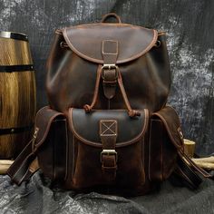 Premium Material: Crafted from 100% Genuine Leather, this backpack features Crazy Horse full grain top layer leather, known for its rich, rugged appearance, and exceptional durability. 🌲 The use of Crazy Horse leather adds a touch of adventure and robust elegance to the backpack. Classic Color Choices: Available in Brown and Dark Brown, these timeless color options suit various styles and preferences. 🎨 The classic color choices ensure versatility, making it easy to complement different outfit Luxury Brown Leather Backpack For Men, Luxury Brown Backpack With Gold-tone Hardware, Leather School Bag, Leather Travel Backpack, Popular Backpacks, Leather Backpack For Men, Vintage Elements, Leather Backpacks, Laptop Rucksack