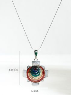 A .950 sterling silver chakana-shaped pendant showcases seven circular chakra colors. Includes such stones and shells as chrysocolla, lapis, spondylus, and mother of pearl. Handcrafted in Cuzco, Peru. Multicolor Medallion Necklace Spiritual Style, Multicolor Medallion Pendant Jewelry, Spiritual Multicolor Sterling Silver Necklace, Multicolor Spiritual Jewelry With Large Pendant, Multicolor Round Amulet Pendant Jewelry, Multicolor Round Jewelry With Polished Finish, Multicolor Polished Round Jewelry, Multicolor Spiritual Jewelry With Inlay, Spiritual Jewelry Pendant With Inlay