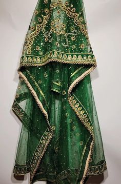 Absolute one of a kind, hand crafted green beaded net shawl. This shawl is a show stopper! Take notice of the heavily embroidered border and beaded centre, that would adorn any bride it is placed upon. We absolutely stand by our products and will be here to support you along your whole shopping journey. You can also find us on Instagram @AfghanWeddingThingss Feel free to send any inquiries about any of our products. Embellished Green Lehenga With Traditional Drape, Green Embellished Lehenga For Festivals, Festive Green Embellished Dupatta, Dark Green Dupatta For Wedding And Festivals, Dark Green Wedding Dupatta For Festivals, Bohemian Green Lehenga With Sheer Dupatta, Green Embroidered Shawl For Festivals, Bohemian Green Lehenga With Intricate Embroidery, Traditional Dark Green Wedding Dupatta