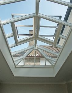 an open skylight in a room with white walls