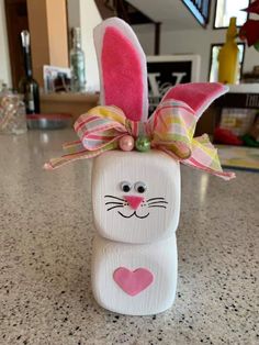 an easter bunny made out of toilet paper with a bow on it's head