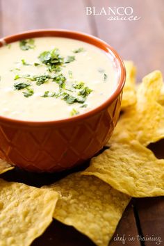 a bowl of quesadilla dip surrounded by tortilla chips