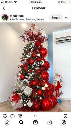 the christmas tree is decorated with red and white ornaments