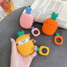 the pineapples are being held up by someone's hand with glasses on them