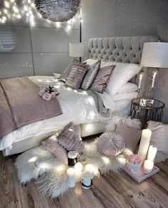 a bedroom with candles and pillows on the floor