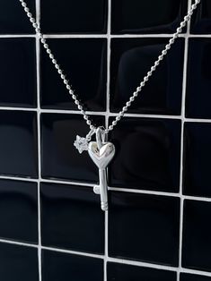 Unlock the power of love with our 925 Sterling Silver Heart Key Necklace! Crafted with a heart shaped key and adorned with a star sparkle gem, this hypoallergenic necklace is perfect for daily wear and won't irritate sensitive skins. material: 925 sterling silver length: 16" +2" extension, total 18 " ball necklace diameter: 1.6mm key pendant measurements: 25 mm (excluding bail) X 10mm Silver Star Charm Necklaces For Anniversary, Silver Heart Necklace With Star Charm, Silver Star Charm Necklace For Anniversary, Silver Open Heart Clavicle Chain Necklace, Valentine's Day Silver Jewelry With Star Charm, Heart-shaped Necklace With Two Keys For Gift, Silver Pendant Charm Necklace With Star Charm, Silver Pendant Charm Necklaces With Star Charm, Heart-shaped Necklace With Star Charm As A Gift