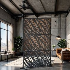 a room divider in an industrial building with large windows and potted plants on the side