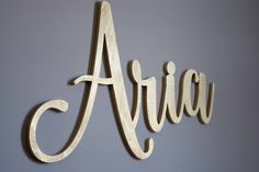 a wooden sign that says airway hanging on the side of a wall in front of a blue wall