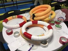 several life preservers are arranged on a table