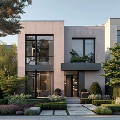 a modern house with lots of windows and landscaping