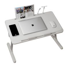 an apple computer sitting on top of a white desk