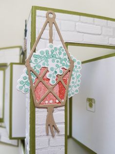 a close up of a handmade card with a bag hanging from it's side