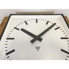 a white clock with black hands and numbers