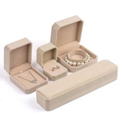 an assortment of jewelry and ring boxes on a white background