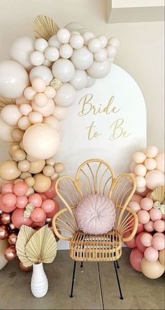 the balloon arch is decorated with pink, gold and white balloons for a bridal to be party