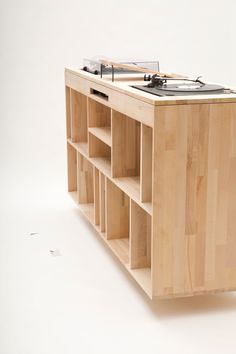 a wooden shelf with an electronic device on it's top and shelves below the shelf