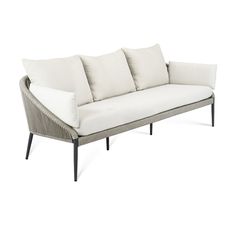 a white couch with four pillows on it's back and side, against a white background