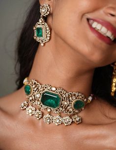 Stunning and gorgeous, CZ stones studded very fine quality Sabyasachi Victorian Emerald/Ruby/Spphire Doublet Stone Shoker necklaces with matching Earrings Antique Victorian Gold rhodium plated Earrings length: Approx 2 inches Earrings Closure: Pushback Necklace Closure: Adjustable Cord Highest quality and craftsmanship Customized orders takes 3 to 4 weeks, depending on piece requirements.  The Ombre Designs Jewelry pieces can be customized in accordance with your requirement.  Please Email or Wh Real Gold Bridal Jewellery Indian, Luxury Kundan Earrings With Stone Setting, Luxury Kundan Necklace With Matching Earrings, Indian Emerald Jewellery, Bollywood Style Jeweled Bridal Earrings, Fusion Style Diamond Bridal Necklace For Reception, Fusion Style Jeweled Bridal Necklace For Wedding, Fusion Style Diamond Kundan Necklace For Wedding, Jeweled Chandbali Bridal Necklace