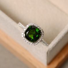 Classic Green Cubic Zirconia Halo Ring, Elegant Green Cubic Zirconia Halo Ring, Elegant Green Halo Ring With Cubic Zirconia, Green Sterling Silver Halo Ring With Prong Setting, Green Sterling Silver Halo Ring With Center Stone, Sterling Silver Green Halo Ring, Green Sterling Silver Halo Ring, Green Halo Jewelry In Sterling Silver, Green Cushion Cut Jewelry With Halo Setting