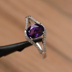 It is natural amethyst ring, the main stone is about 6mm*8mm, oval cut, weight about 1.14 carats.The basic metal is sterling silver and plated with rhodium.To change the metal to a solid gold (white/rose) or platinum is also available, please ask for a quotation if you want.You can also go to my shop Home for more elegant rings: https://www.etsy.com/shop/godjewelry?ref=hdr_shop_menuAmethyst is February birthstone.More amethyst rings:https://www.etsy.com/shop/godjewelry?ref=seller-platform-mcnav& Oval Amethyst Ring With Cubic Zirconia In Prong Setting, Oval Amethyst Ring With Prong Setting In Cubic Zirconia, Purple Amethyst Oval Diamond Ring, Oval Amethyst Cubic Zirconia Promise Ring, Oval Amethyst Ring With Cubic Zirconia For Promise, Elegant Amethyst Birthstone Open Ring, Oval Amethyst Cubic Zirconia Ring, Elegant Amethyst Open Birthstone Ring, Oval Purple Amethyst Ring With Cubic Zirconia